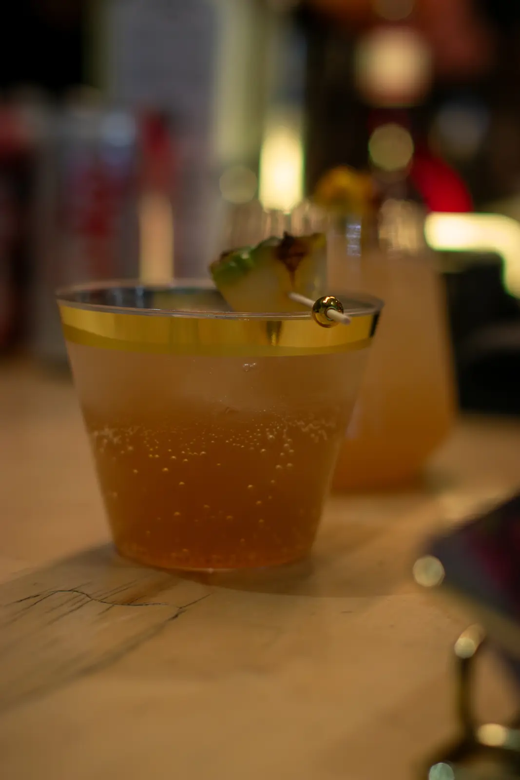 A golden signature cocktail prepared for a Top Shelf Spirit event