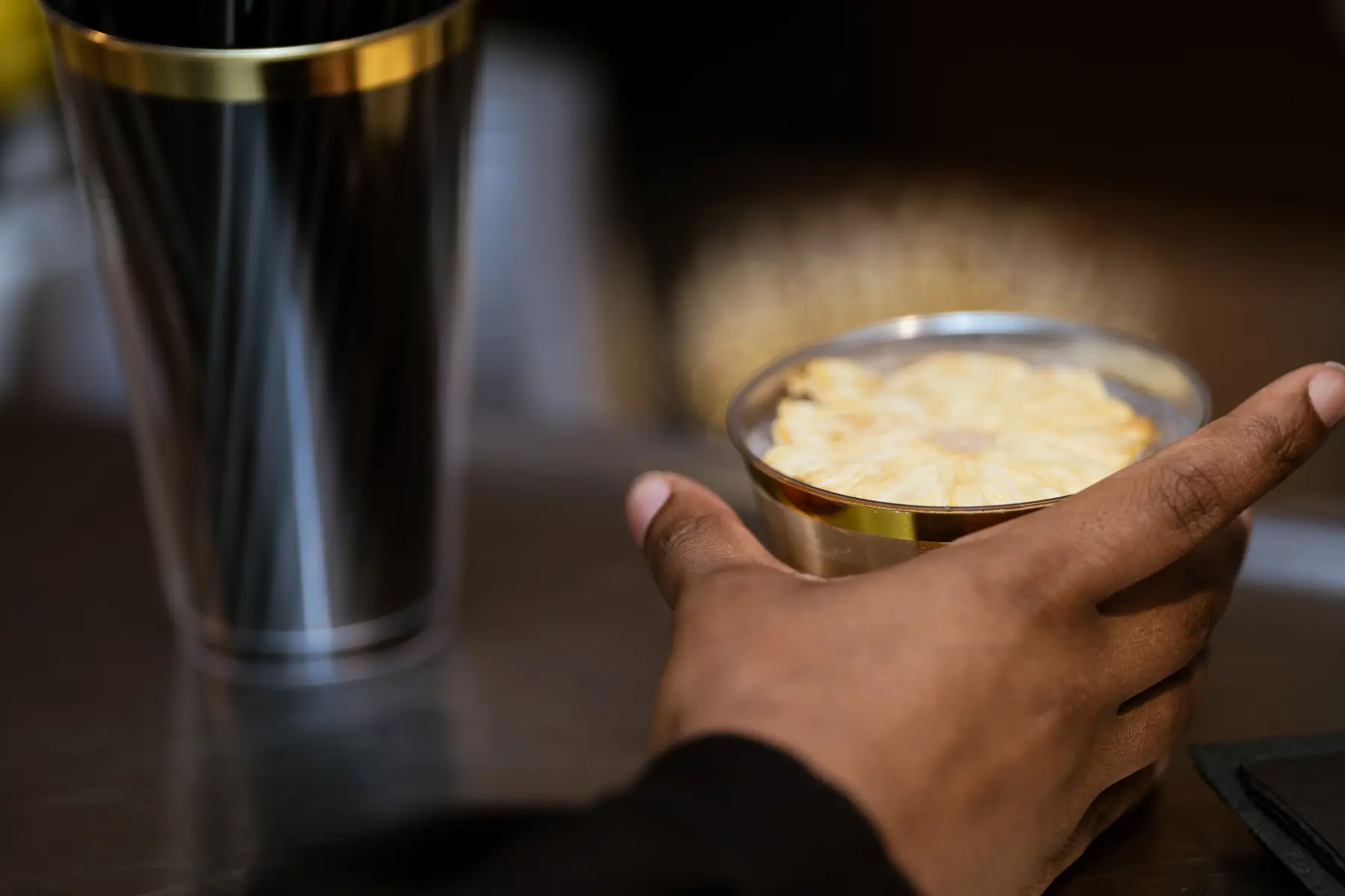 A pineapple-garnished cocktail being served at a Top Shelf Spirit event